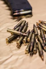 Pile of rifle ammunition on gold background