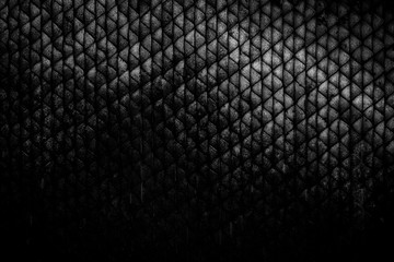 Abstract background of dirty and weathered triangular shaped pattern. Dark high resolution full frame textured background in black and white.