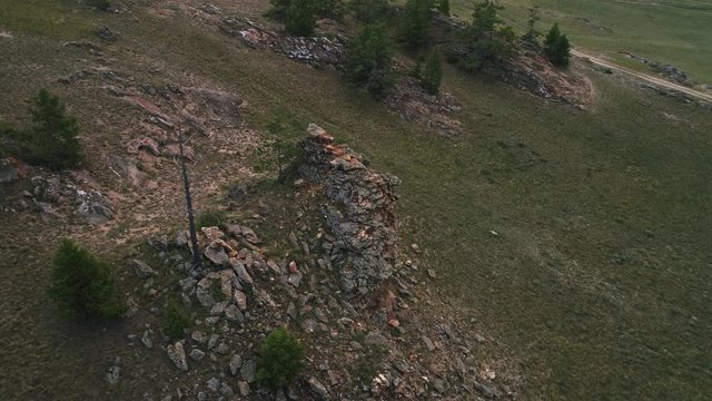 Baikal Valley spirits,Tazheran steppe, stone cliffs on the road. Aerial Summer