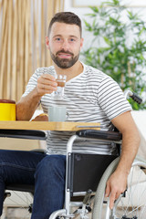 cheerful disabled man drinking tea