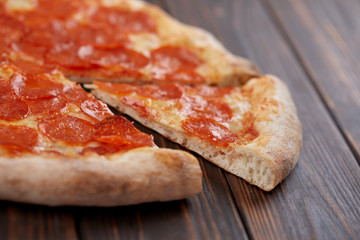 tasty pizza on the wooden background