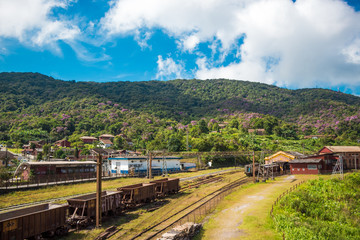 Obraz na płótnie Canvas Train Station in Paranapiacaba, Sao Paulo, Brazil. Old Railway Carriages And Railroad In Historical English Village Among Tropical Green Mountains. Countryside In Santo Andre District. Tourist Place.