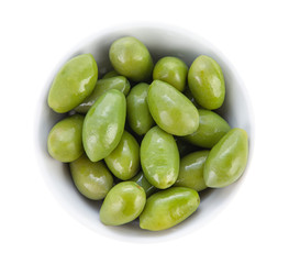 Large olives with cuttings in a porcelain bowl. Top view close up.