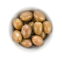 Large olives with cuttings in a porcelain bowl. Top view close up.