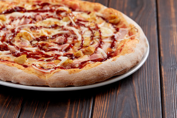 tasty pizza on the wooden background