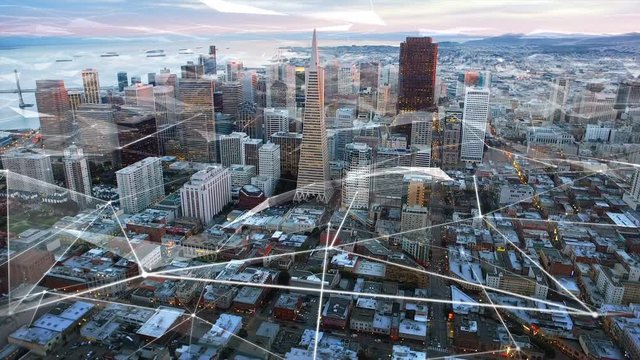 Aerial view of the financial district and the Bay Bridge of San Francisco with futuristic connections. California. United States. Skyline. Shot from helicopter. Technology. 