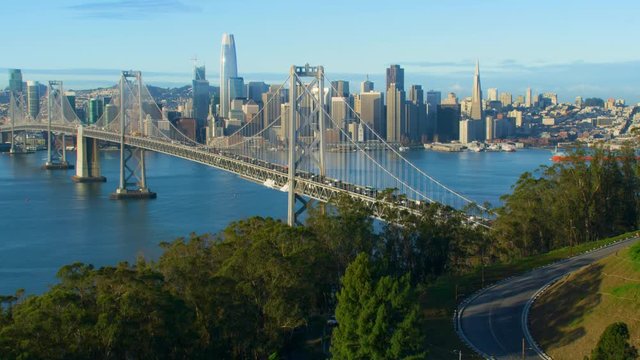 Aerial view of the San Francisco Oakland Bay Bridge. California, US. With traffic. Financial District skyline with its well known skyscrapers. Shot on Red weapon 8K.