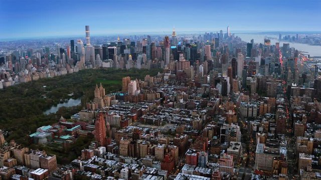Beautiful aerial view of the Central Park in Midtown Manhattan. Iconic skyscrapers as the Freedom Tower and the Empire State Building in the background. New York, United States. Shot from helicopter.