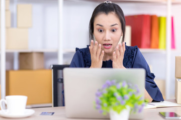 Asian women who are SME online shopping entrepreneurs are shocked when they see a message on the...