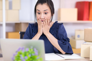 Asian women who are SME online shopping entrepreneurs are shocked when they see a message on the...