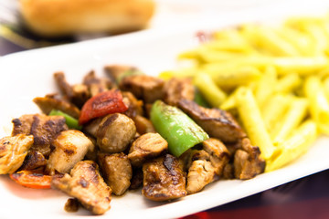 chicken saute meal with green pepper and tomato in white plate