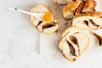 Slices of homemade cinnamon babka or swirl brioche bread. Cinnamon roll bread. Povitica: traditional Polish sweet bread. Light grey background.