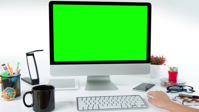 Woman working on a computer. Desk with colorful office elements. Lateral dolly. Chroma Key. Perfect to put your own images or videos. Track with perspective corner pin.   