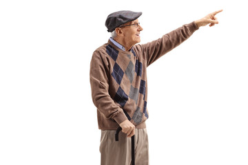 Senior man standing with a cane and pointing up in the distance