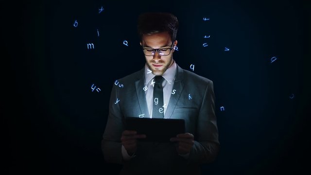 Businessman using a tablet with holographic letters. VR. Futuristic technology. Augmented reality. Blue. 