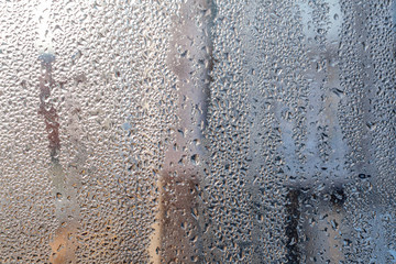 Raindrops on the window. Beautifful raindrops on the misted glass.