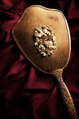 on antique gold hand mirror © Laci Vega