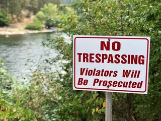 No trespassing sign - river visible in background