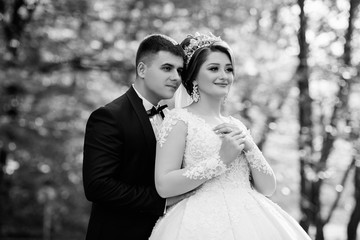 Black and white. Bridal couple, happy newlywed woman and man. Loving wedding couple outdoor. Bride and groom. Happy wedding couple. Romantic sensual moment of newlyweds.