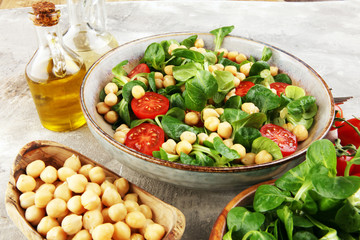 chickpea salad with ingredient and tomatoes and lamb´s lettuce. healthy salad