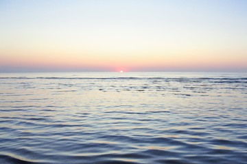 Fototapeta na wymiar defocus. sunrise on the sea. Sea of Azov Ukraine. pink sky and quiet sea surface. view from the shore