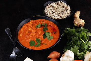 Chicken tikka masala spicy curry meat food in pot with rice and naan bread. indian food