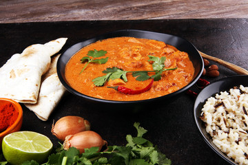Chicken tikka masala spicy curry meat food in pot with rice and naan bread. indian food