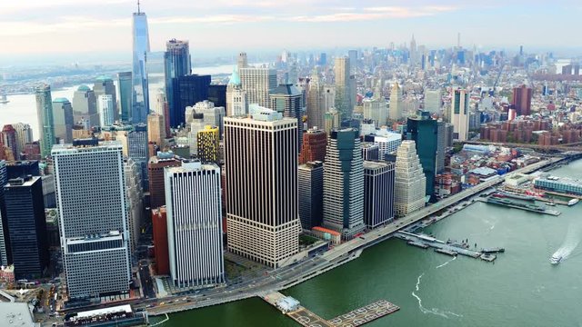 Aerial view above the East River. Famous Manhattan skyscrapers. Traffic passing by FDR Drive. Manhattan. United States, North America. Shot from a helicopter.   