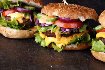 Tasty fresh meat burgers with salad and cheese. Homemade angus burger.