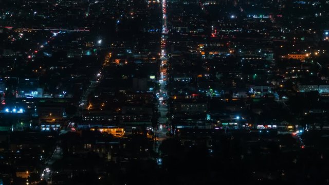 Beautiful view of Los Angeles from Griffith Observatory. Shinning city lights and traffic. California. Timelapse. Zoom out.