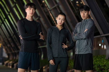 Young friends running at night