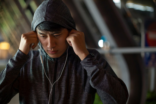 Young man with earphones running