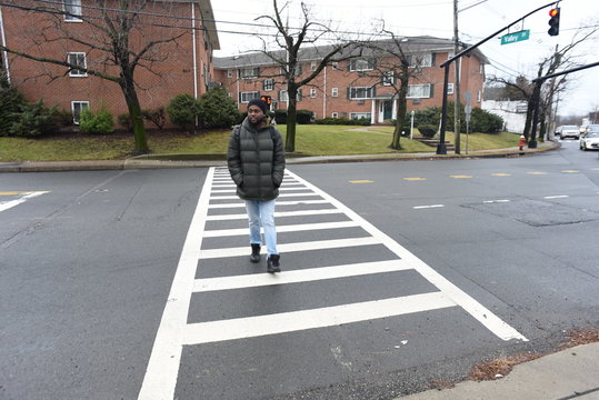 African American pressing the cross button. safety first. A black hand pressing a knob. A cute man trying to cross the road. A man waiting the walk on the zebra crossing