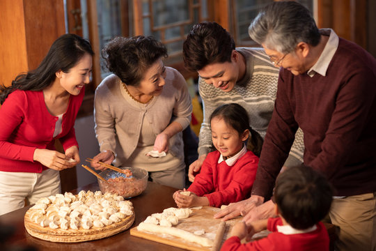 Happy family making dumplings