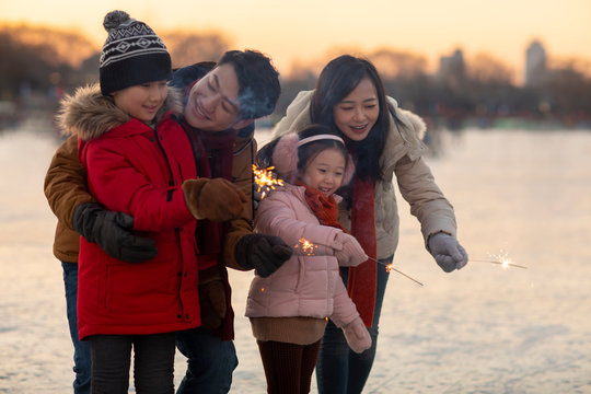 Happy young family with sparklers