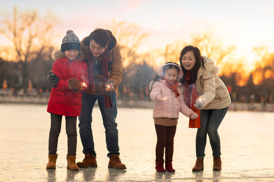 Happy young family with sparklers