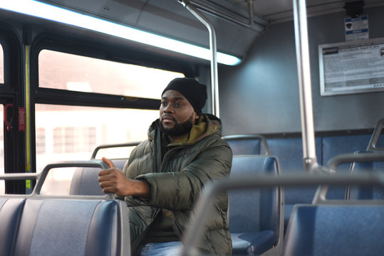 African American Man On A Bus, Going To Work In The Morning. Everyday Man Commuting To Work By Public Transport. Handsome Man Traveling To Work. 