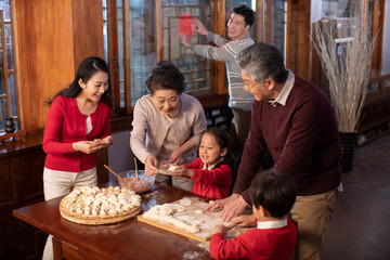 Happy family making dumplings
