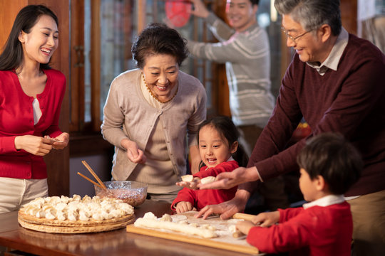 Happy family making dumplings