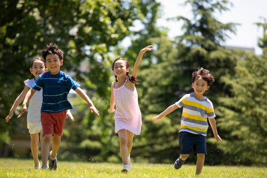 Happy children playing on meadow