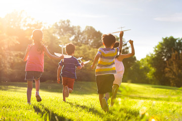 Happy children playing on meadow