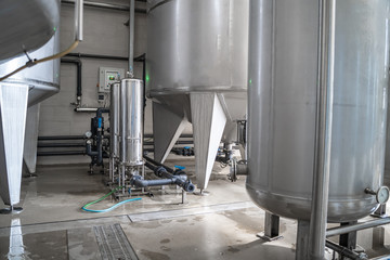 Water plant production or brewery. Large steel tanks for filtering and potable water treatment. Industry background.