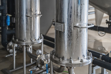 Close up of steel tubes or pipes for filtering and potable water treatment or brewery production manufacturing. Industry background.