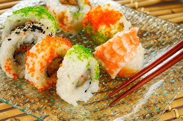 Assortment of Japanese Futomaki roll seafood and chopsticks in Asian fast food restaurant.