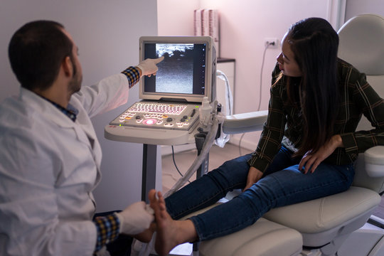 Podiatry doctor using ultrasound scanner