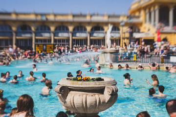 Budapest Spa Szechenyi Thermal Bath spa swimming pool with blue sky in summer day with a crowd of...