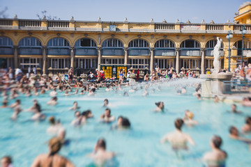 Budapest Spa Szechenyi Thermal Bath spa swimming pool with blue sky in summer day with a crowd of...