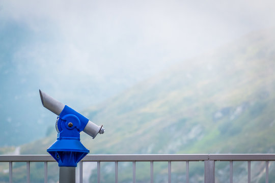 Viewing platform with coin-operated telescope in Austrian mountains in misty weather with zero visibility