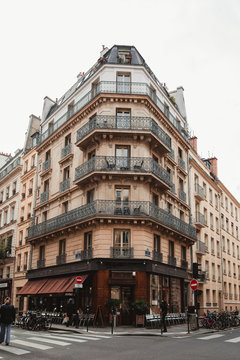 Low angle of aged building with cafe in Paris on sunny day