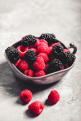 Fresh berries raspberries, blackberries on a gray art background. Healthy food, summer berries